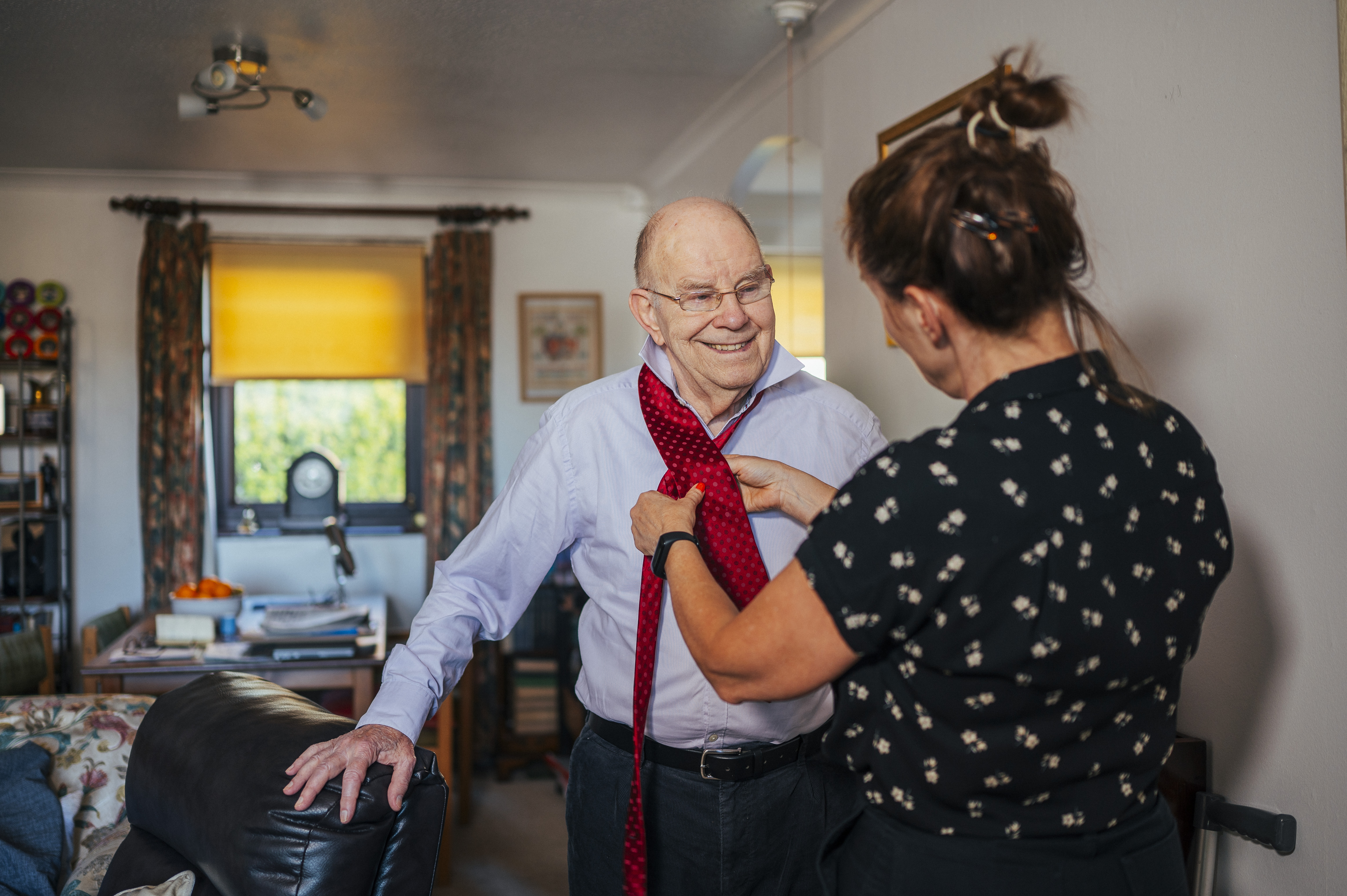 Person tying a tie